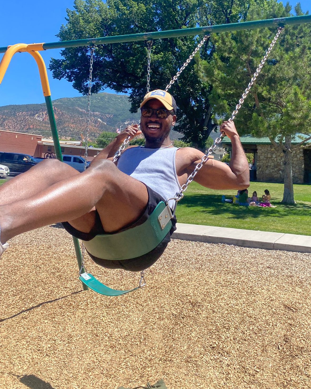 Ozzy laughing on a park swing